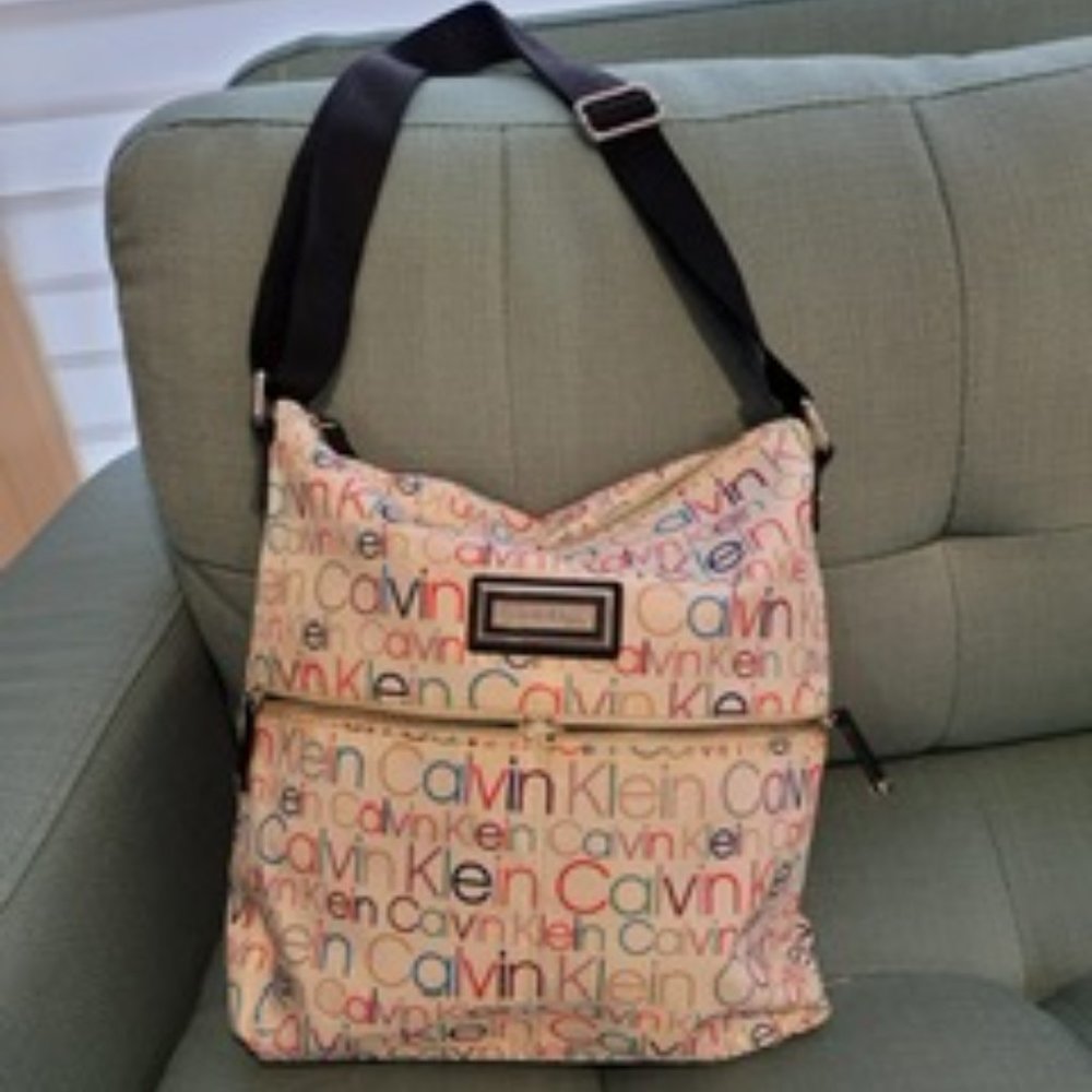 White fabric crossbody bag with colorful writting
